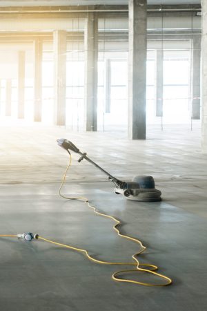 floor polishing machine inside a large industrial building, not people